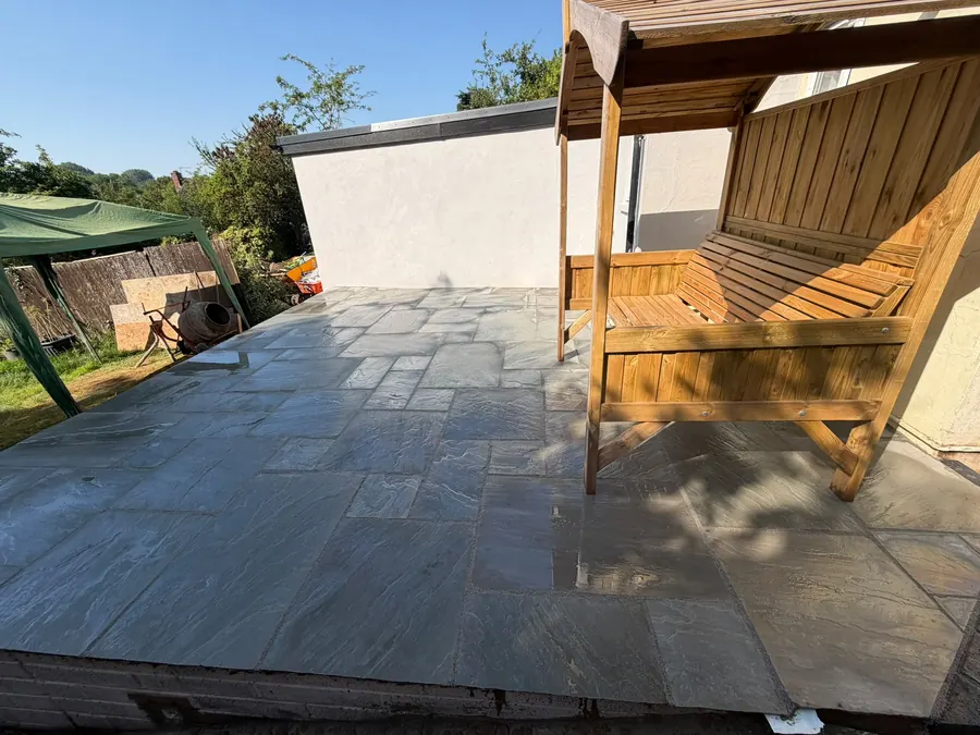A finished patio with timber garden furniture set back out on it