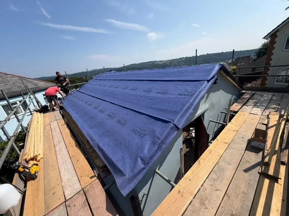 Breather membrane felt fitted across a roof before tiling